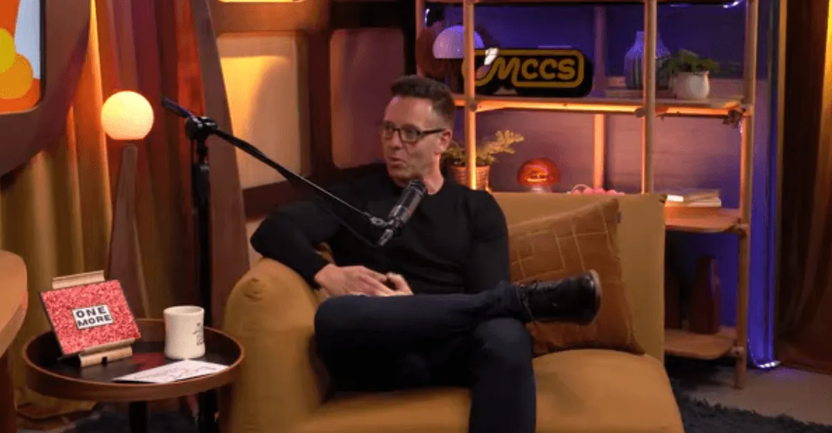 John Edward speaking into a mic on 'The Mitch Churi Chat Show'