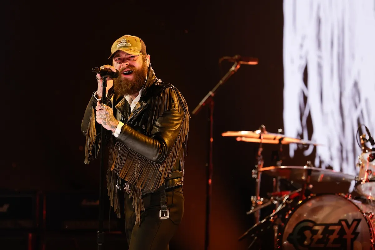 Post Malone singing into a microphone at the 68th Grammy Awards