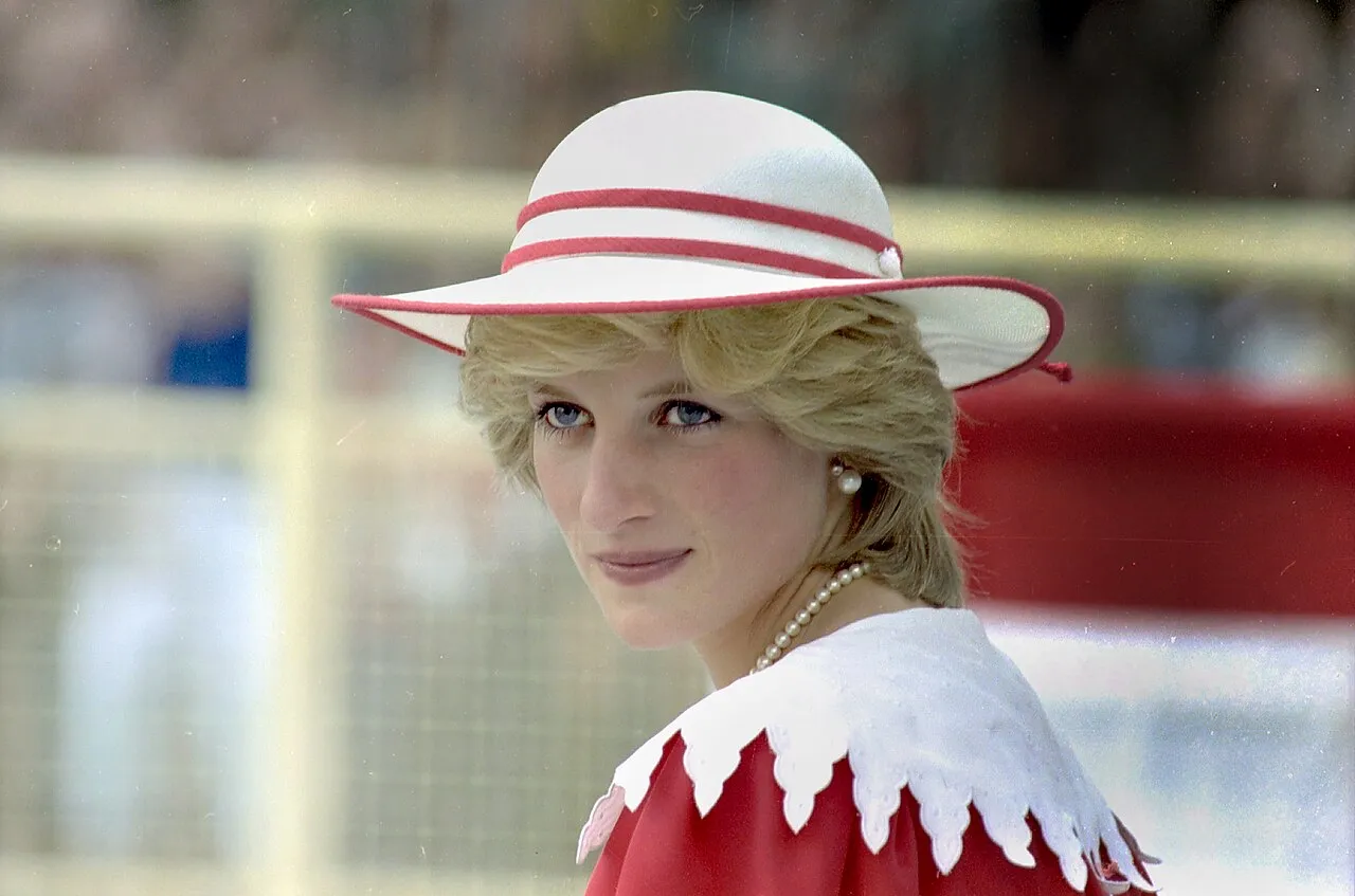 Princess diana in a white hat with red trim