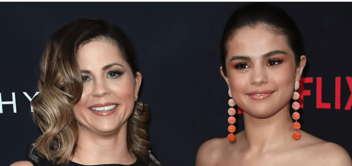 Selena Gomez wears orange earrings and stands with her mom, Mandy Teefey.