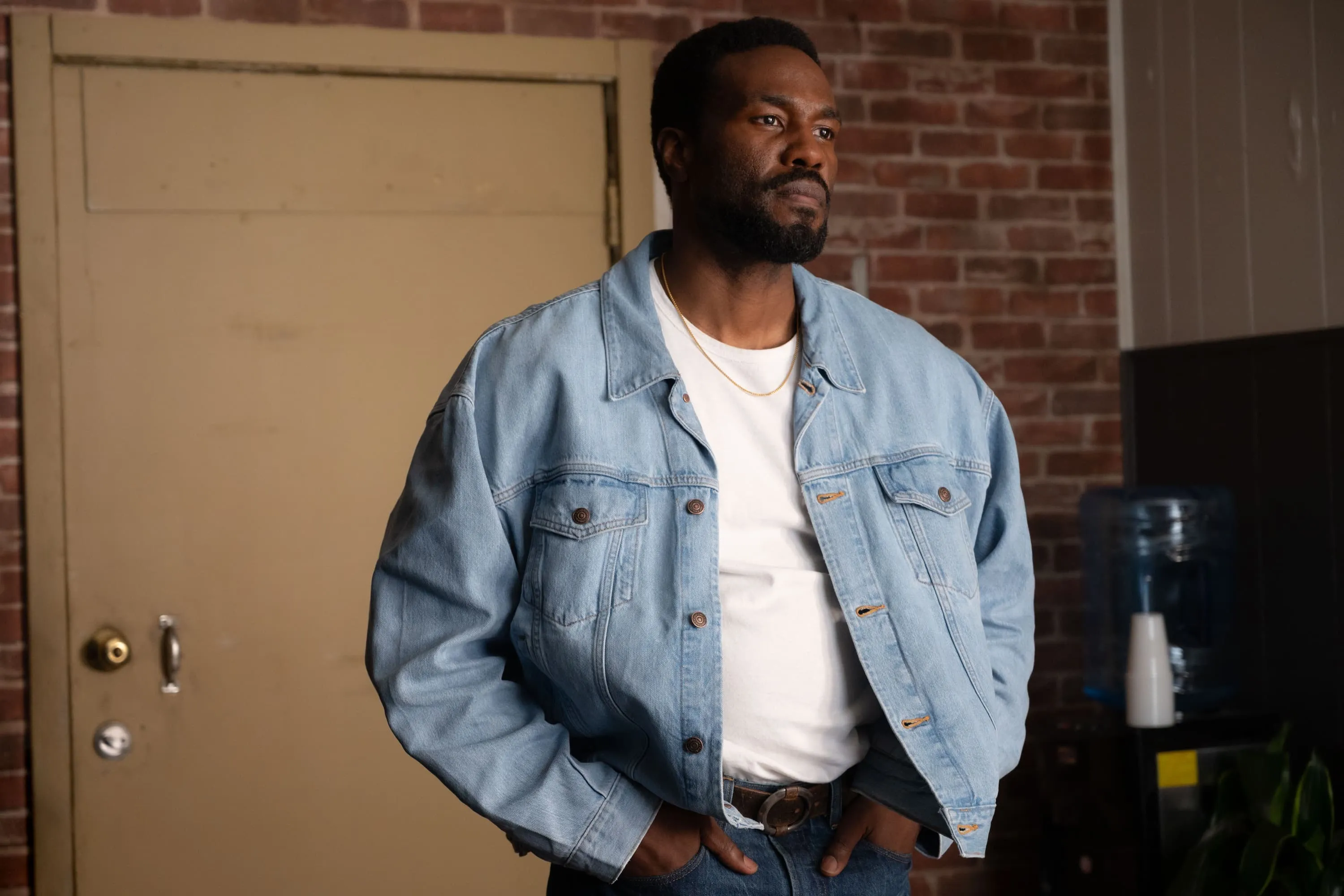 Yahya Abdul-Mateen wearing a denim jacket and white shirt in Wonder Man
