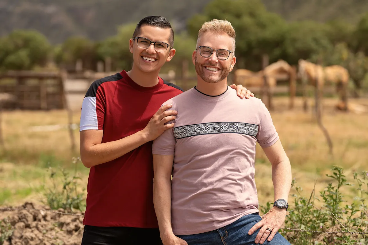 Portrait of Kenny and Armando from '90 Day Fiance' with horses in the background