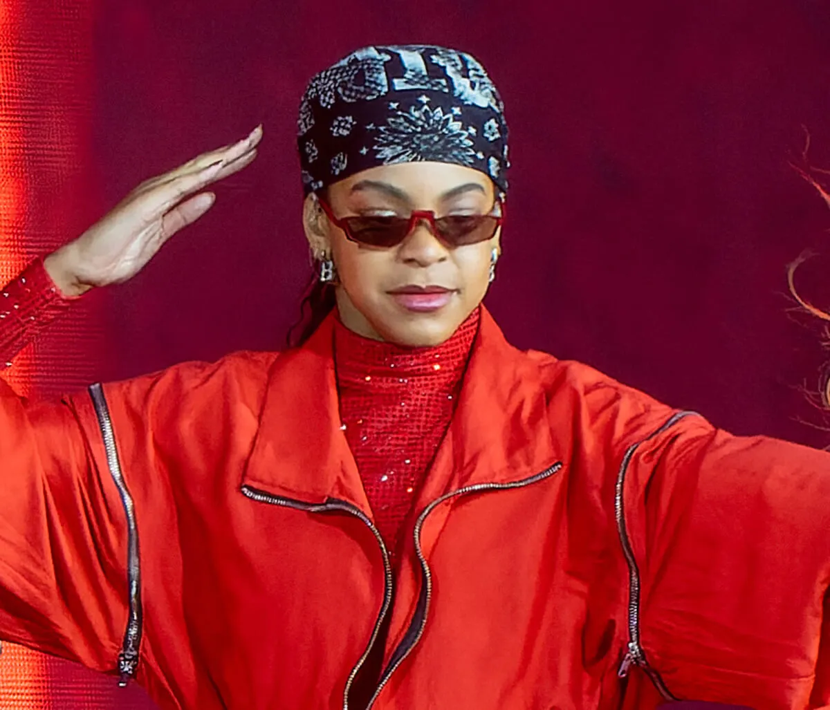 Blue Ivy wears a red turtleneck and jacket with sunglasses and a bandana.