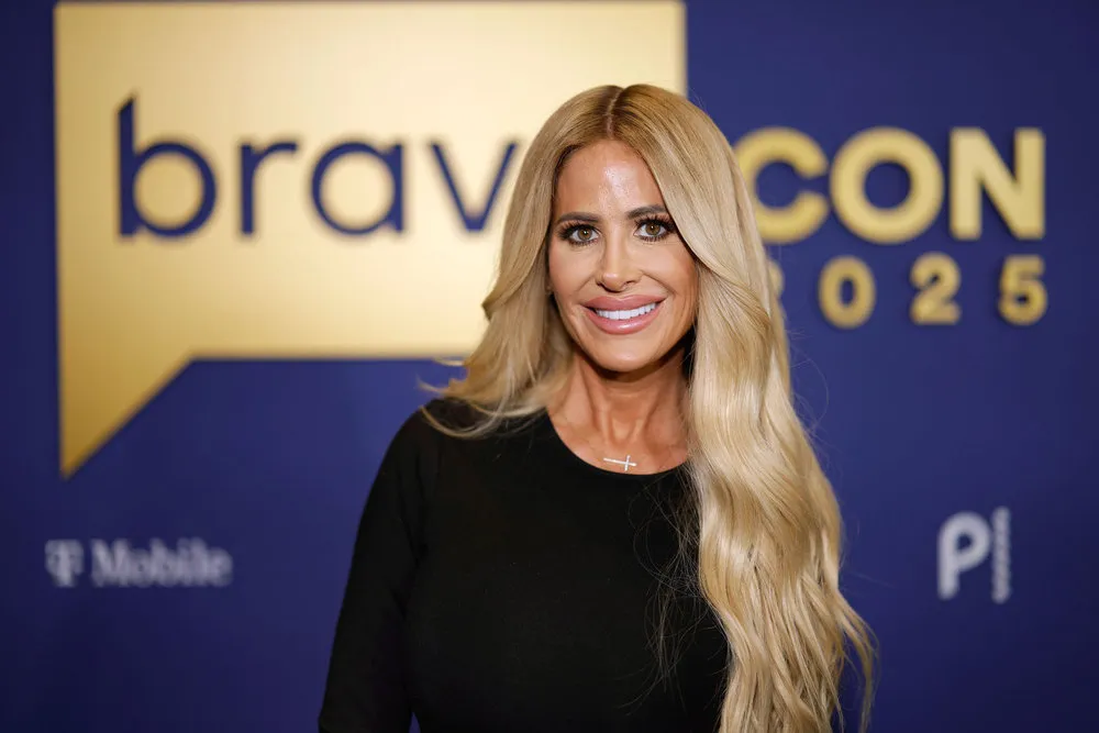 Kim Zolciak wears a black shirt and smiles.