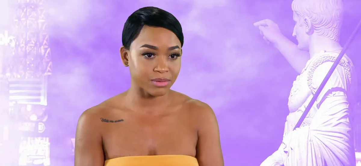 Nikki Hall with short hair and wearing a strapless yellow top in 'Double Shot at Love'