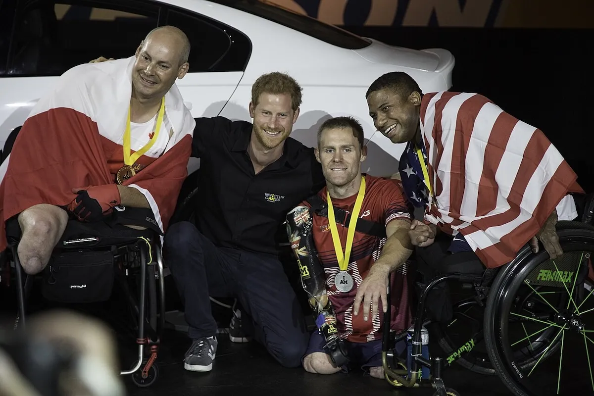 Prince Harry poses for a photo with three athletes at the Invictus Games