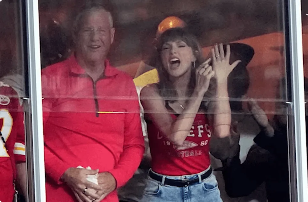 Screenshot of Taylor Swift pointing to her ring during Chiefs game