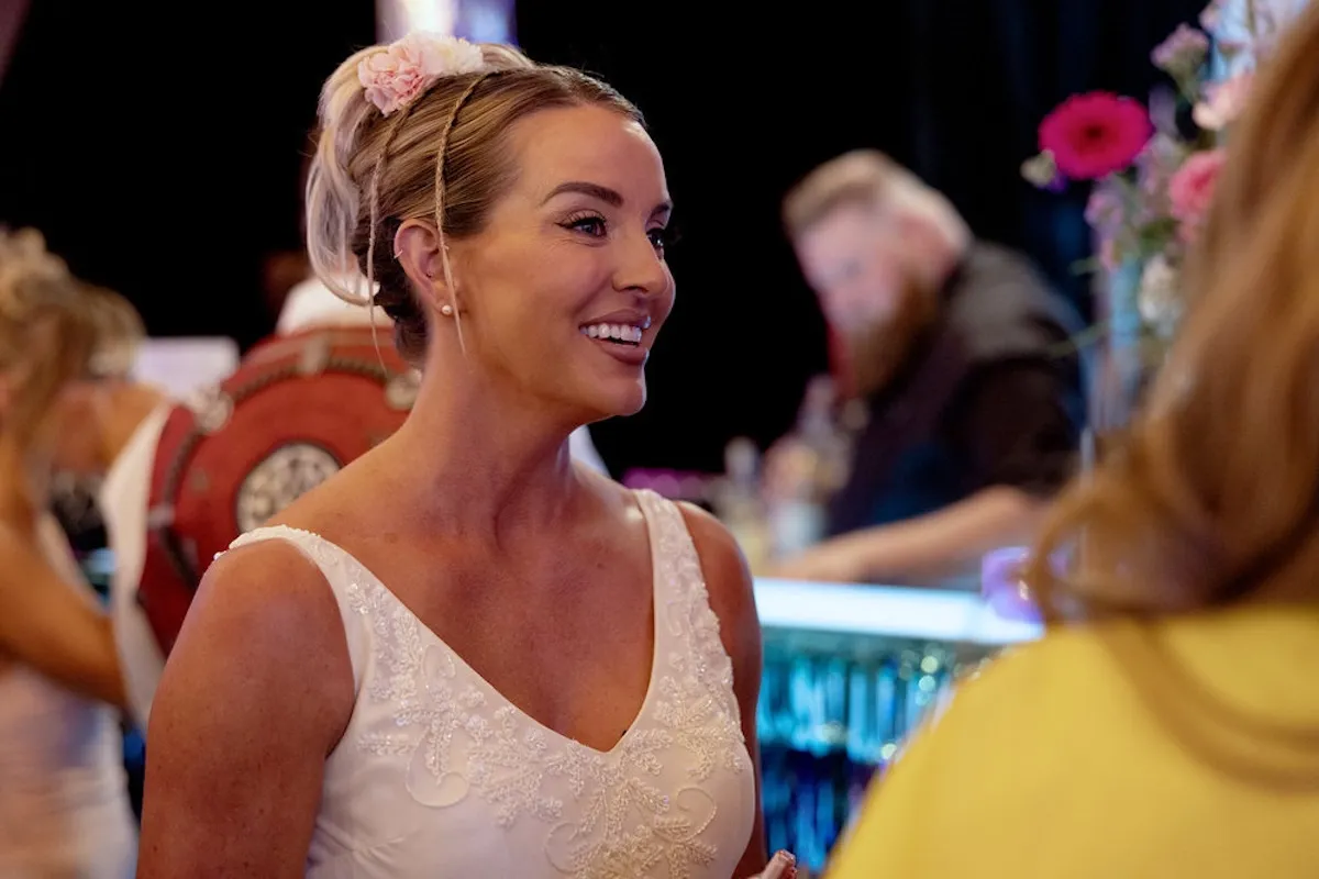 Smiling Whitney Rose in a white dress in 'The Real Housewives of Salt Lake City'