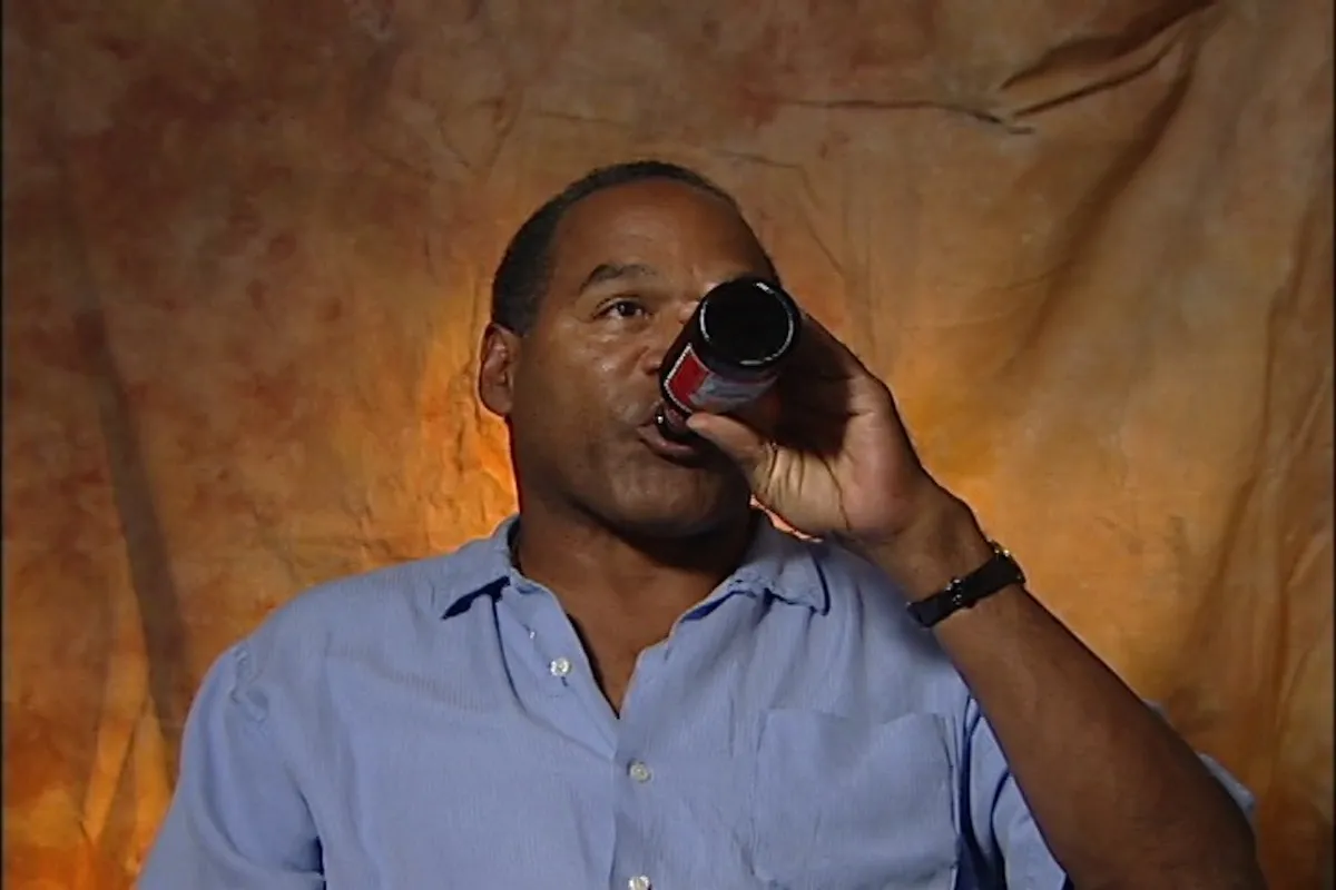 oj simpson drinking a bottle of beer in interview segment from ID's 'o.j. unseen: exploitation of evil.'