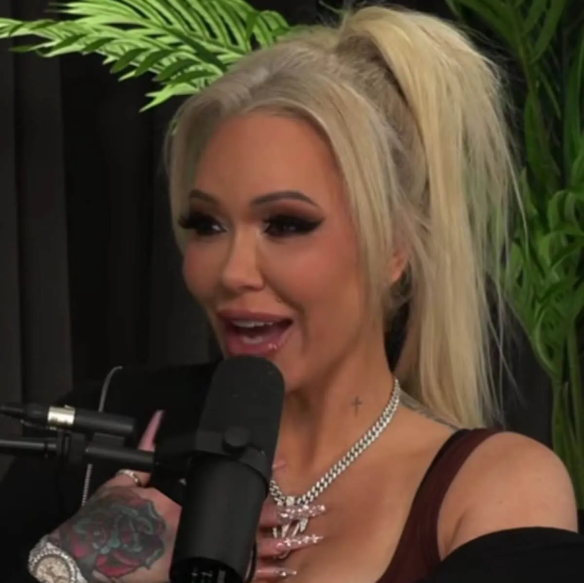 Bunnie Xo wears black and sits in front of a microphone.