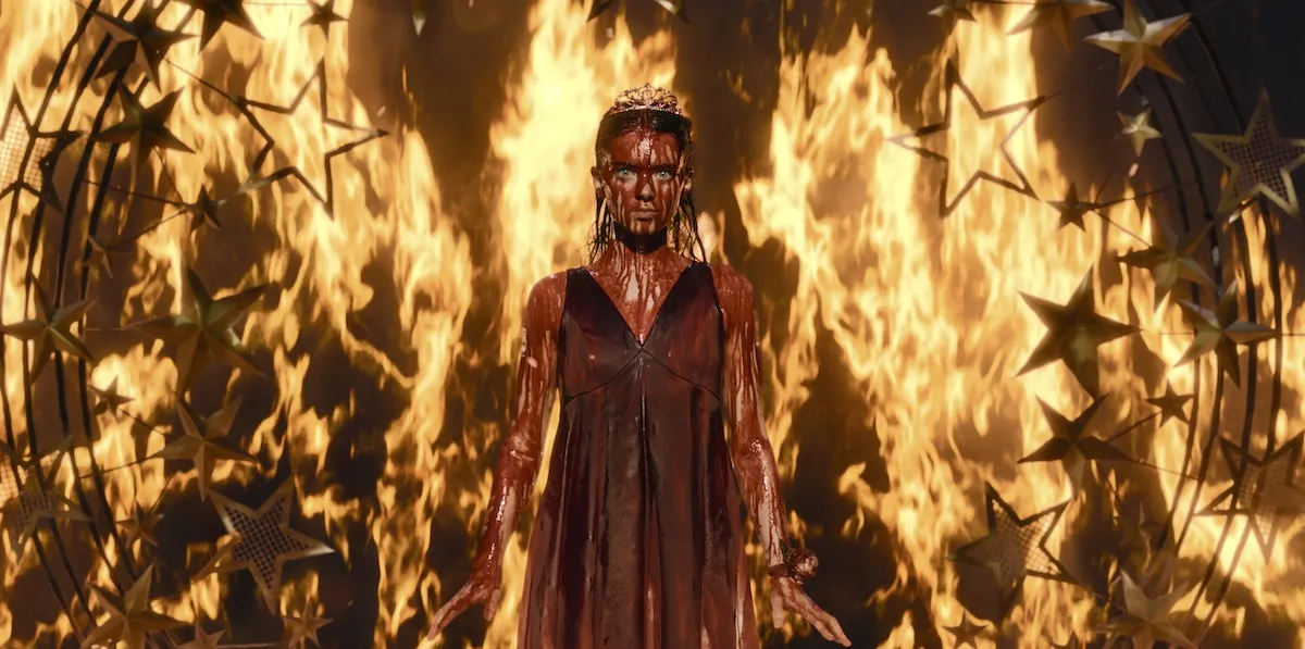 Bloody Carrie White in front of a wall of flames in the 'Carrie' season finale