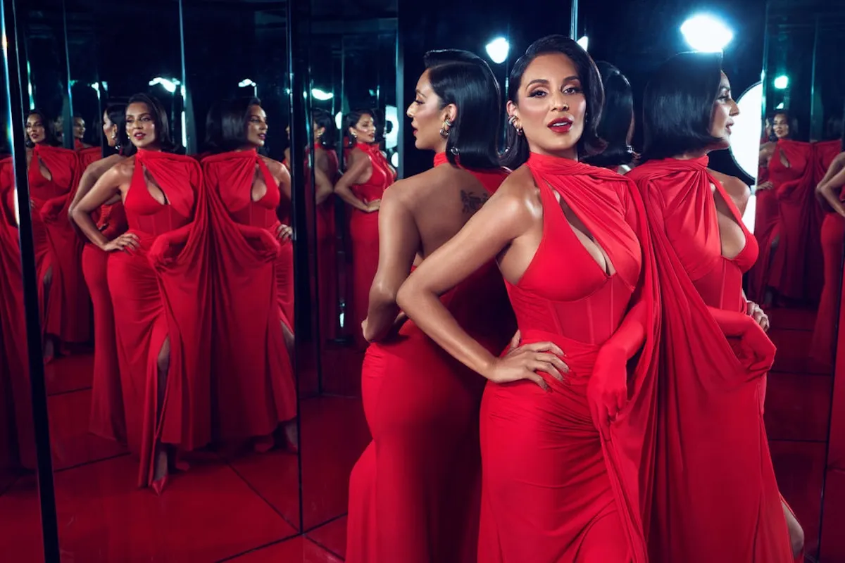 Jessel Taank of 'The Real Housewives of New York City' posing in front of mirrors in a red dress