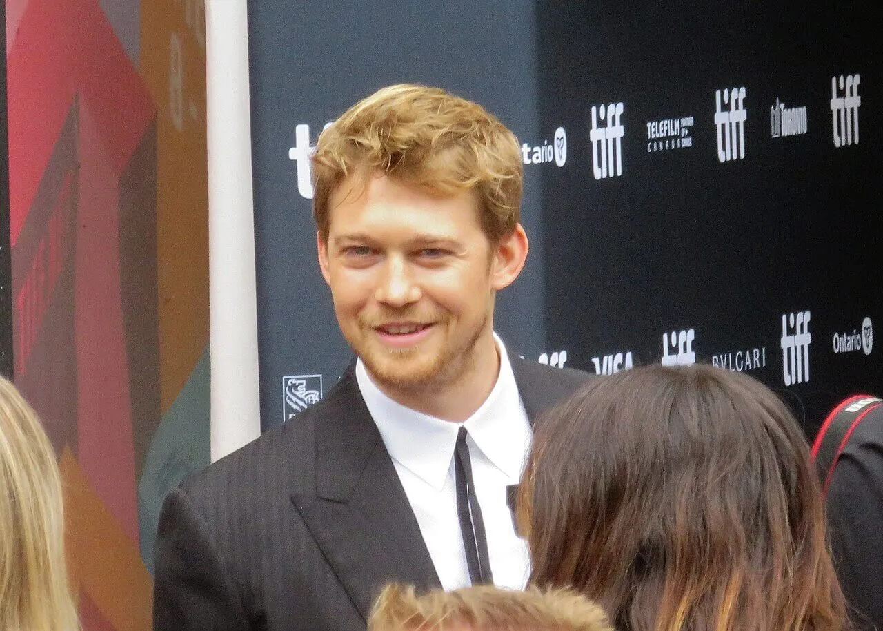 Joe Alwyn wears a suit.