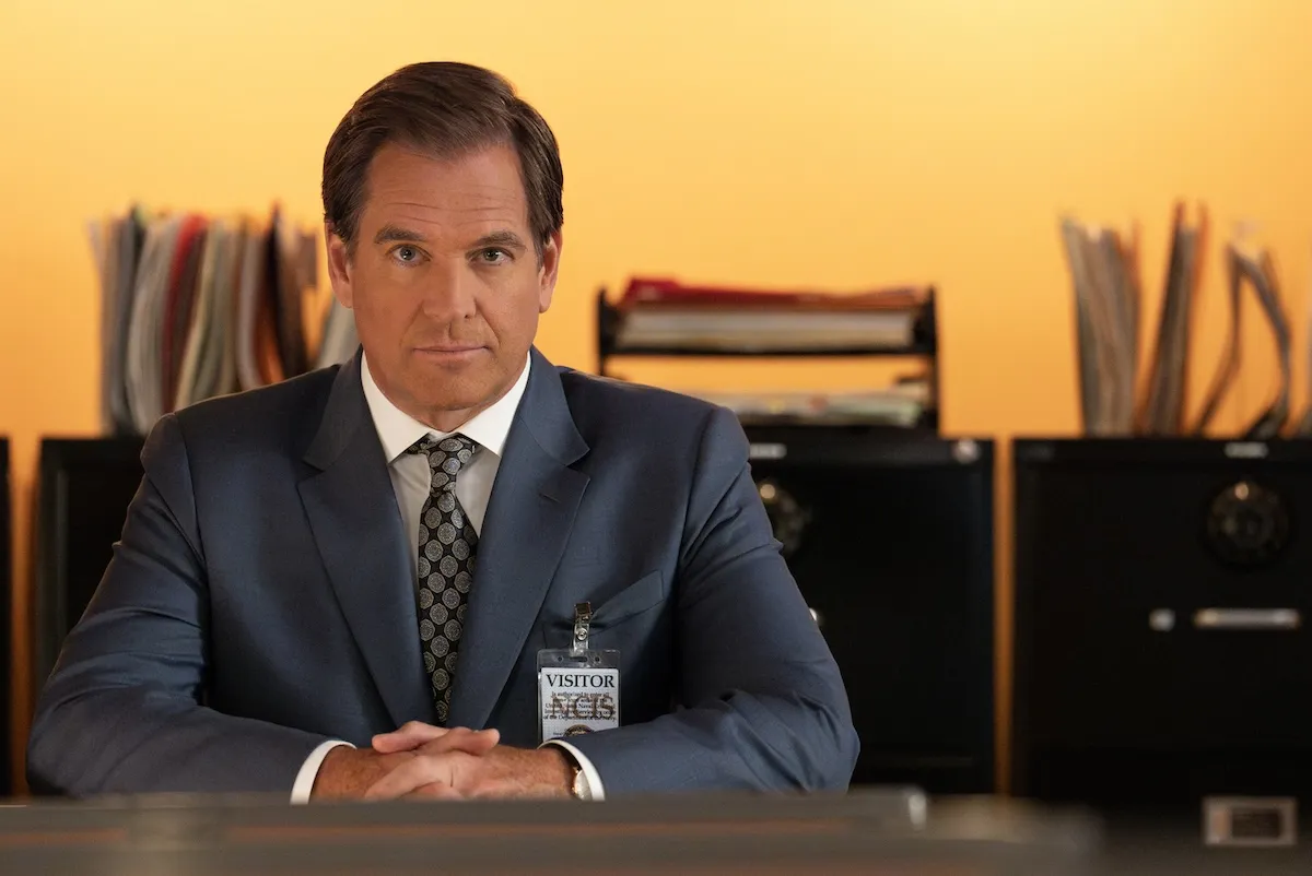 Michael Weatherly in a suit sitting at a desk in 'NCIS' Season 24