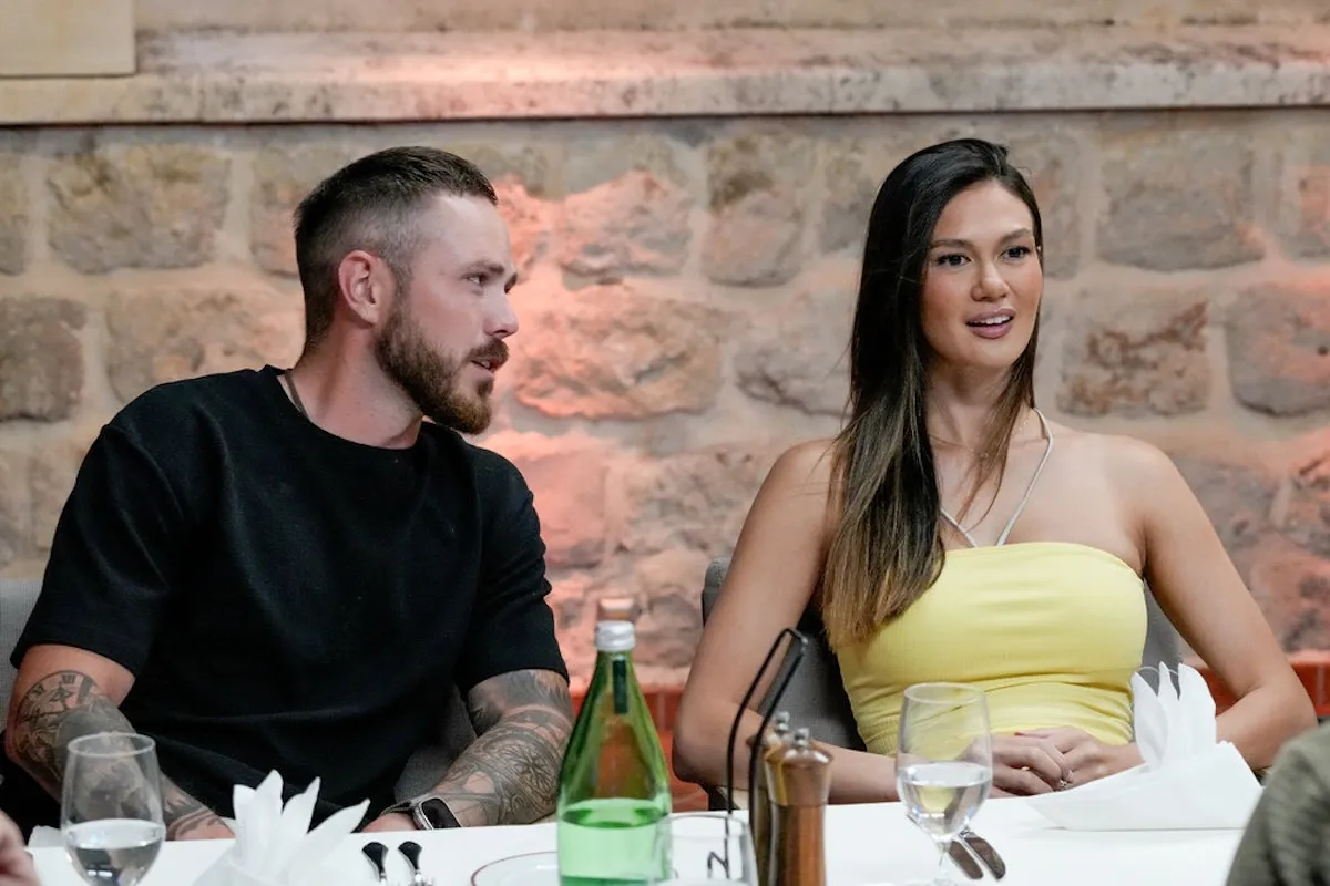 Nathan Gallagher and Gael Cameron sitting next to each other at a dinner in 'Below Deck Med' Season 11