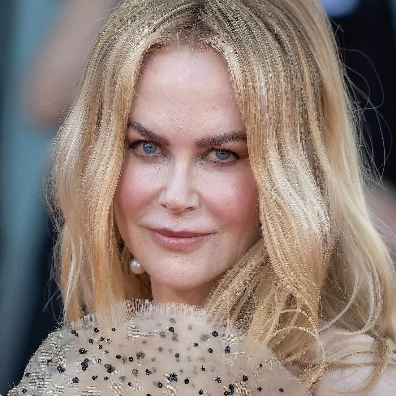 Nicole Kidman wears a dress with a high collar.
