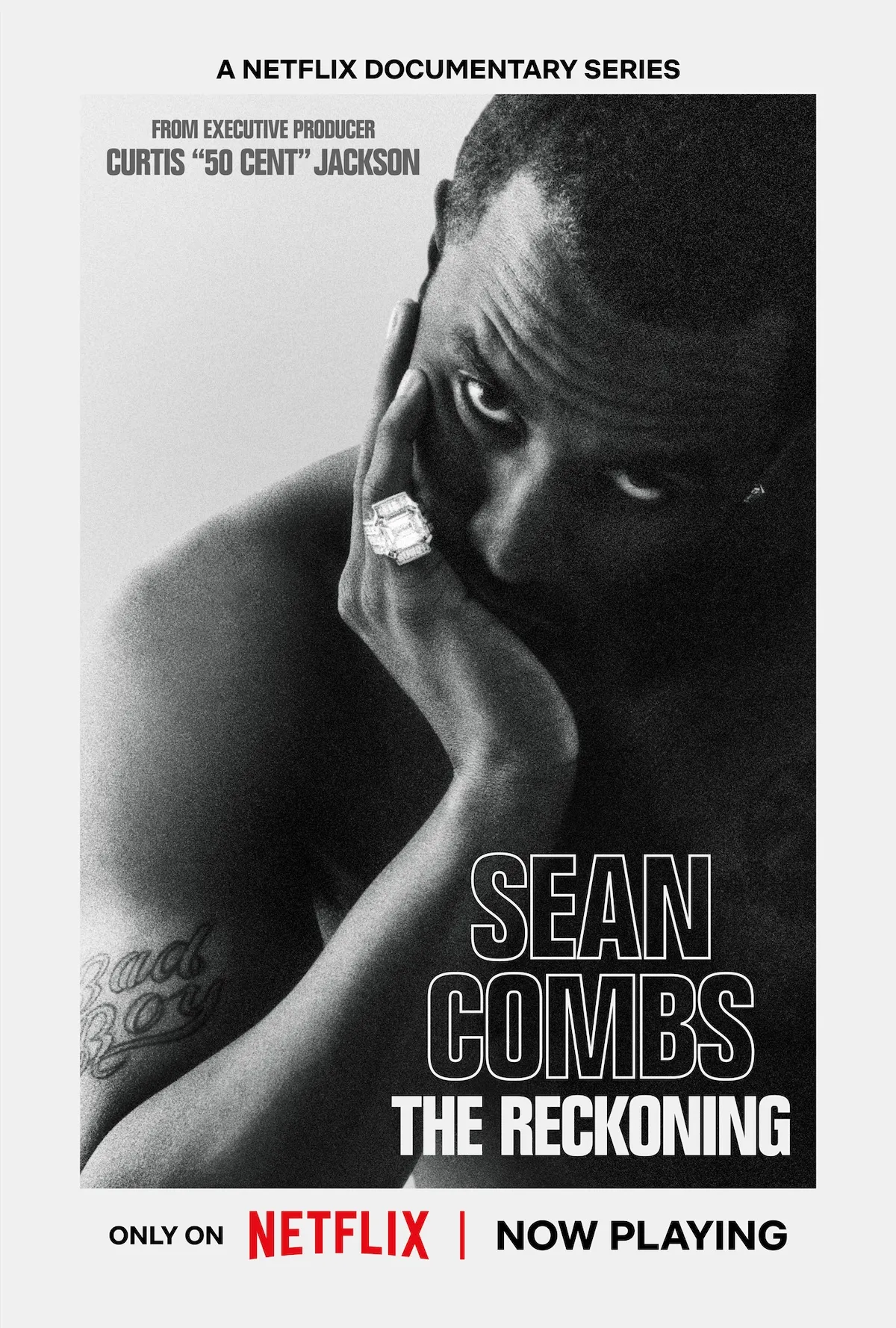 Key art for 'Sean Combs: The Reckoning' on Netflix featuring a black and white photo of Diddy with his chin in his hand