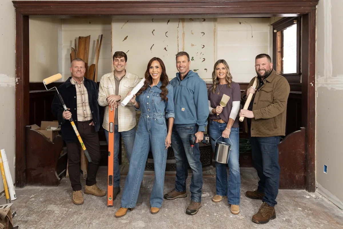 Cast of 'Betting on Beloit' posing with construction tools